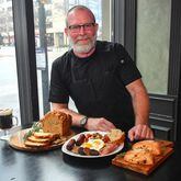 Fadó Irish Pub corporate chef Bryan McAlister poses with (from left) Fadó Irish Coffee, Fadó Guinness Cheddar Bread, Fadó Irish Breakfast and Fadó Cranberry-Thyme Scones. STYLING BY BRYAN MCALISTER / CONTRIBUTED BY CHRIS HUNT PHOTOGRAPHY