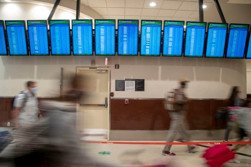 Travelers pass by in the Domestic Terminal at Hartsfield-Jackson Atlanta International Airport earlier this month. It could take months or years for American business travel to return to normal, which spells uncertainty for metro Atlanta’s economy. (Alyssa Pointer / Alyssa.Pointer@ajc.com)