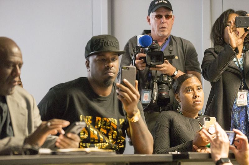 04/30/2018 — Norcross, GA - Activist Yonasda Lonewolf, seated far right, sits with other protestors as they watch a Saraland Waffle House security video during a press conference at the Waffle House corporate campus headquarters in Norcross, Monday, April 30, 2018. After holding a press conference outside the building, a Waffle House spokesperson invited the protestors inside to watch the recently released security video of 25-year-old, Chikesia Clemons, being violently arrested. ALYSSA POINTER/ALYSSA.POINTER@AJC.COM