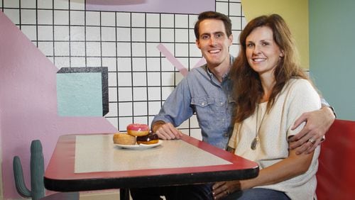 Owners Jeremy and Kelsey Turner sit at the dining table in The McFly house listed on Airbnb. They decorated the home in all 80’s decor. (Brian Elledge/The Dallas Morning News/TNS)
