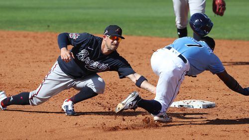 Atlanta Braves second baseman Sean Kazmar tags Tampa Bay Rays infielder Vidal Brujan out on a steal attempt Sunday, Feb. 28, 2021, at Charlotte Sports Park in Port Charlotte, Fla. (Curtis Compton / Curtis.Compton@ajc.com)