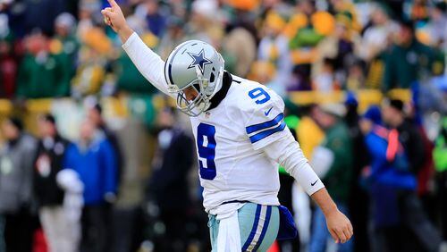 GREEN BAY, WI - JANUARY 11: Quarterback Tony Romo #9 of the Dallas Cowboys reacts after the Cowboys scored against the Green Bay Packers in the second qaurter of the 2015 NFC Divisional Playoff game at Lambeau Field on January 11, 2015 in Green Bay, Wisconsin. (Photo by Rob Carr/Getty Images)