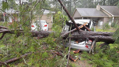 September 11, 2017 Columbus - A fallen tree damaged two cars at Monica Ogle's home on Dearborn Ave in west of Columbus on Monday, September 11, 2017. He had to move his car to a safe parking spot. The Georgia coast was hit hard Monday morning, with pounding rains, roaring winds and storm surge. More than 87,000 Georgia Power customers were without power in the Savannah area, as were another 96,000 from Brunswick and St. Simons south to St. Marys, at the Florida line. HYOSUB SHIN / HSHIN@AJC.COM