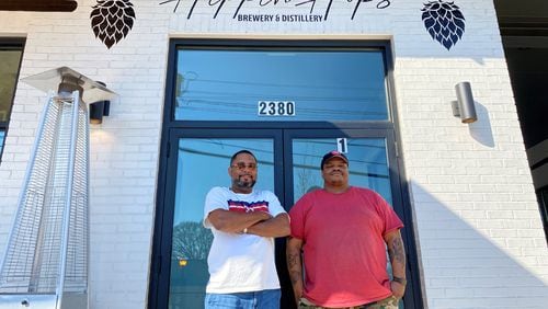Owner Clarence Boston (left) and brewer Kevin Blodger are seen in front of Hippin Hops Brewery and Distillery in East Lake. Bob Townsend for The Atlanta Journal Constitution