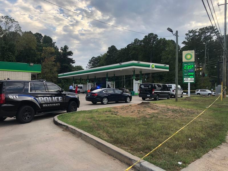 Three men are wanted on murder charges after a man was gunned down at a DeKalb gas station Monday.