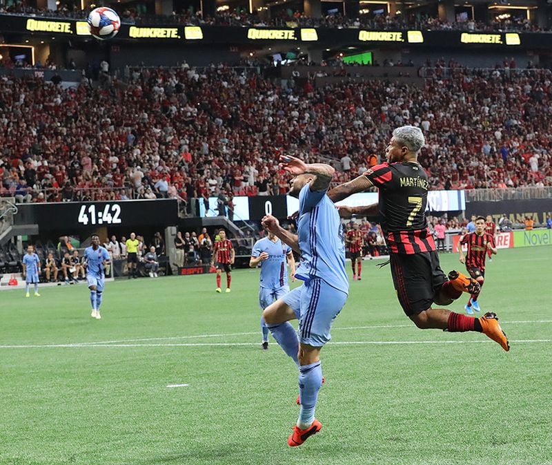 Striker Josef Martinez goes up for a header over New York City FC defender Maxime Chanot that gave Atlanta United a 1-0 lead Sunday, Aug. 11, 2019, at Mercedes-Benz Stadium in Atlanta.