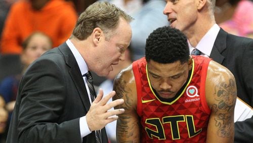 Former Hawks head coach Mike Budenholzer confers with Kent Bazemore during a time out against the Cavaliers in a NBA basketball game on Thursday, November 30, 2017, in Atlanta.  Curtis Compton/ccompton@ajc.com