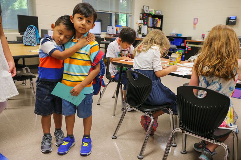 Jeremiah, 4, (left) says goodbye to big brother Jacob Cabarelli, 6, (right) before starting kindergarten at Mountain View elementary school in Cobb County on Monday, July 31, 2017.