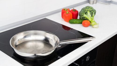 Induction cooktops use electromagnetism to generate heat instead of an open flame or coil, making them an aging-in-place essential. (Dreamstime)