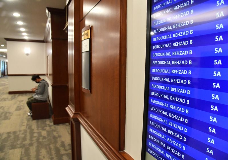 A screen displaying an April 20 docket at Atlanta Municipal Court shows that Pavilion Place owner Behzad Beroukhai was scheduled for a hearing on a long list of code enforcement cases. Neither he nor his lawyers appeared. (Hyosub Shin / hyosub.shin@ajc.com)