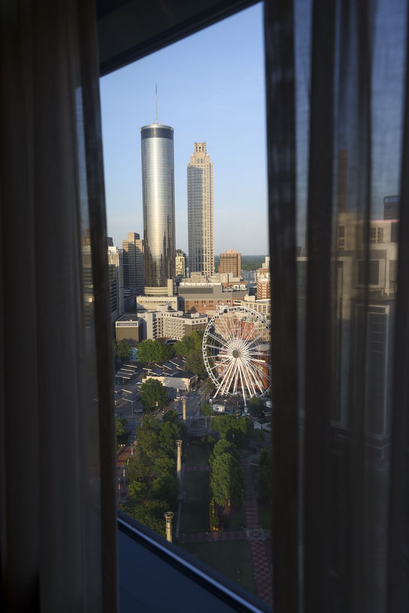 The Atlanta skyline is shown in the master bedroom of the Presidential suite is shown on the 28th floor in the newly remodeled top floor of the hotel’s North Tower of the Omni Atlanta Hotel at Centennial Park, Thursday, May 2, 2024, in Atlanta. Omni Atlanta Hotel hosted an event celebrating the newly remodeled rooms including three “Legacy Suites.” (Jason Getz / AJC)