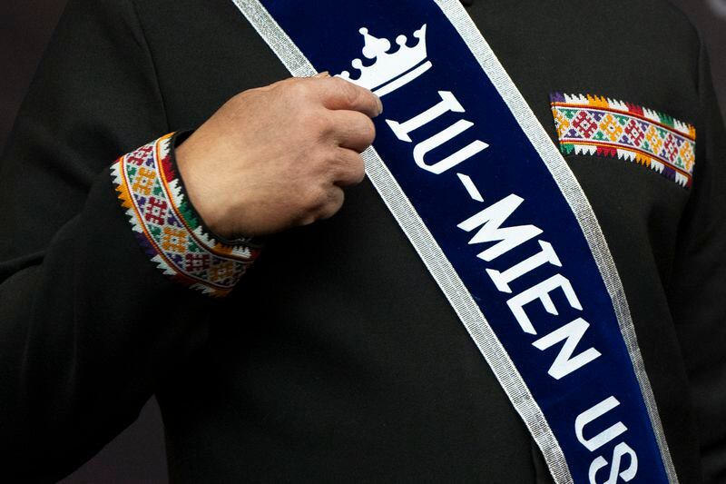 Cheng "Charlie" Saephan points to his sash that reads "Iu-Mien USA" while speaking during a news conference after it was revealed that he was one of the winners of the $1.3 billion Powerball jackpot at the Oregon Lottery headquarters, Monday, April 29, 2024, in Salem, Ore. (AP Photo/Jenny Kane)