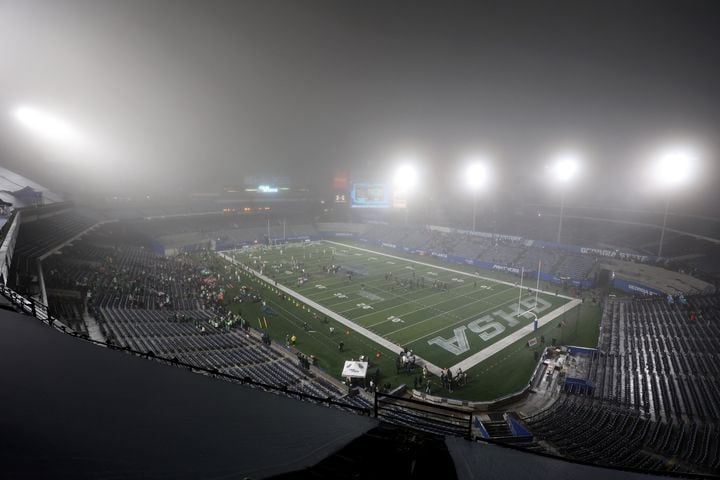 Fog fills the sky as Buford and Langston Hughes warm-up before the start of the Class 6A state title football game at Georgia State Center Parc Stadium Friday, December 10, 2021, Atlanta. JASON GETZ FOR THE ATLANTA JOURNAL-CONSTITUTION