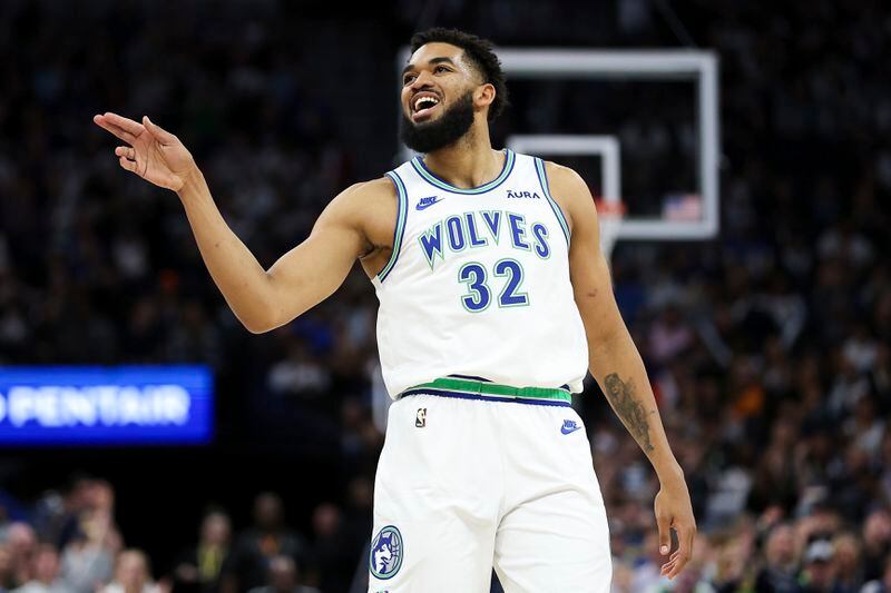 Minnesota Timberwolves center Karl-Anthony Towns (32) celebrates his 3-point basket against the Phoenix Suns during the first half of an NBA basketball game, Sunday, April 14, 2024, in Minneapolis. (AP Photo/Matt Krohn)