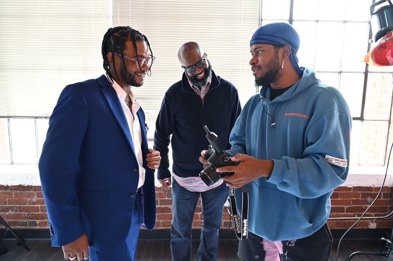 Photographer Spliff Dalcoe (right) shares preview images with Kevin "Keats" Jackman and his manager Charles Smith (center) at Cam Kirk Studios in Atlanta on Thursday, Nov. 5, 2020. (Hyosub Shin / Hyosub.Shin@ajc.com)
