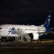 A plastic sheet covers an area of the fuselage of the Alaska Airlines N704AL Boeing 737 MAX 9 aircraft outside a hangar at Portland International Airport on Jan. 8, 2024, in Portland, Oregon, following a midair fuselage blowout on Jan. 5. None of the 171 passengers and six crew members were seriously injured. (Mathieu Lewis-Rolland/Getty Images/TNS)