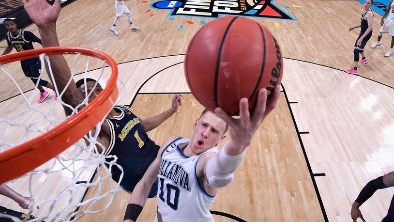 Donte DiVincenzo #10 of the Villanova Wildcats drives to the basket against Charles Matthews #1 of the Michigan Wolverines in the second half during the 2018 NCAA Men's Final Four National Championship game at the Alamodome on April 2, 2018 in San Antonio, Texas.  (Photo by Jamie Schwaberow - Pool/Getty Images)