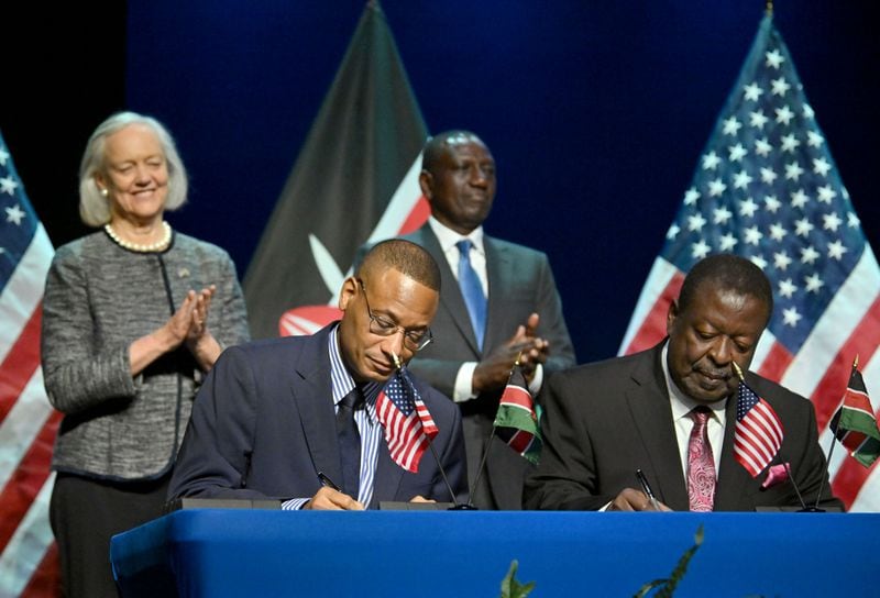 Clinton White (foreground left), U.S. Counselor for USAID, and Musalia Mudavadi, Prime Cabinet Secretary of Kenya, sign a memorandum of understanding as President of the Republic of Kenya, Dr. William Samoei Ruto (background right), and U.S. Ambassador to Kenya Margaret “Meg” Whitman (background right) react, during an event hosted by Spelman College, Tuesday, May 21, 2024, in Atlanta. Spelman College hosted Ruto for a series of events focused on developing a technology bridge between Historically Black Colleges and Universities (HBCUs) and Kenyan scholars in order to lay the groundwork to prepare a generation of future leaders to meet ever-evolving market demands. (Hyosub Shin / AJC)