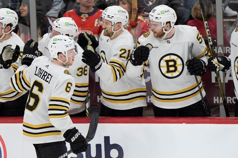 Boston Bruins defenseman Mason Lohrei (6) celebrates his goal with teammates during the second period of Game 1 of the second-round series of the Stanley Cup Playoffs against the Florida Panthers, Monday, May 6, 2024, in Sunrise, Fla. (AP Photo/Wilfredo Lee)