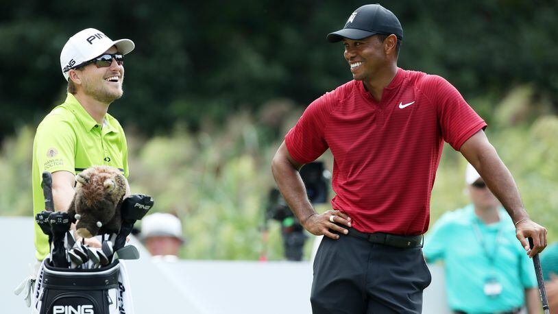 Tiger Woods (right) talks to Austin Cook  on the 12th tee during the final round of The Northern Trust on August 26, 2018 at the Ridgewood Championship Course in Ridgewood, New Jersey.  (Photo by Gregory Shamus/Getty Images)
