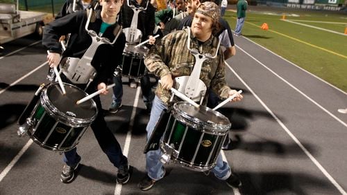 In this 2015 file photo, Roswell Hornets drummers pump up the crowd before their playoff game against  Collins Hill at Roswell High School Stadium.
