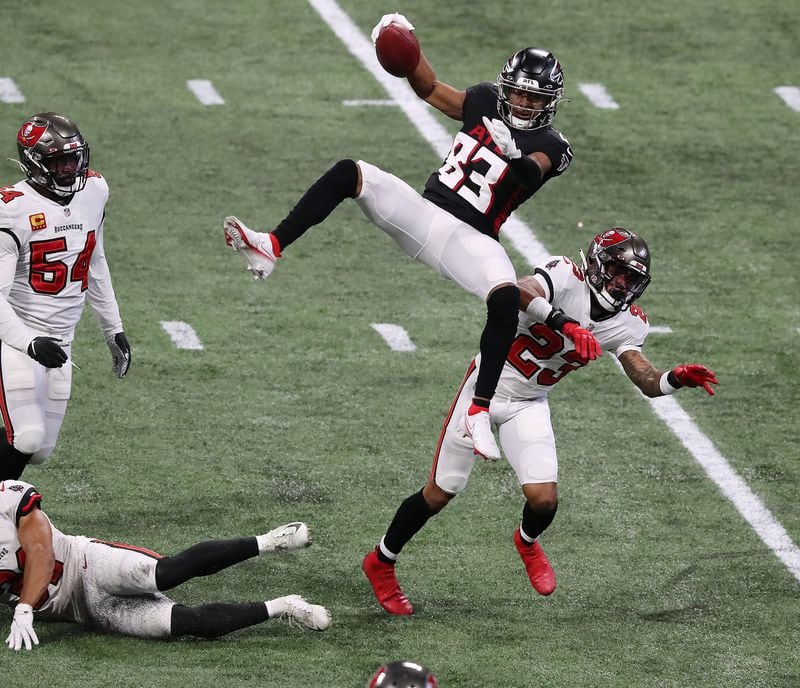 Falcons wide receiver Russell Gage goes up for a first down catch over Tampa Bay Buccaneers cornerback Sean Murphy-Bunting during the second quarter Sunday, Dec. 20, 2020, at Mercedes-Benz Stadium in Atlanta.  (Curtis Compton / Curtis.Compton@ajc.com)