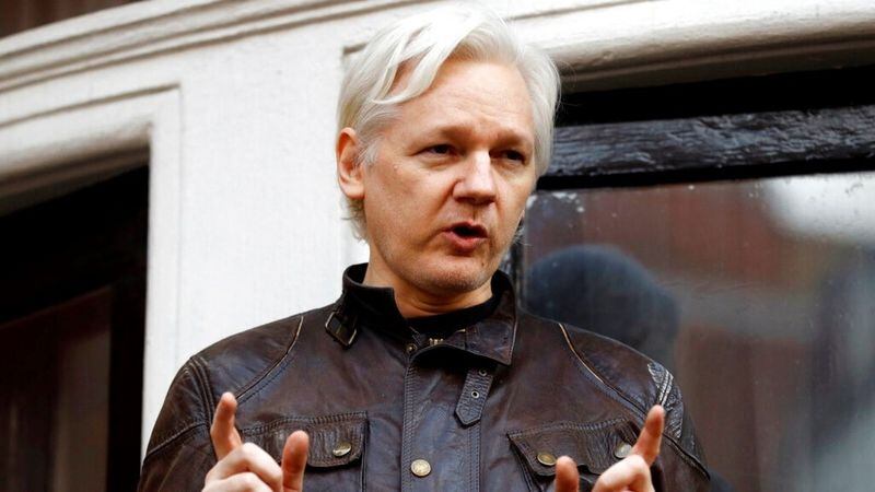 In this May 19, 2017 file photo, WikiLeaks founder Julian Assange gestures to supporters outside the Ecuadorian embassy in London, where he has been in self imposed exile since 2012. 