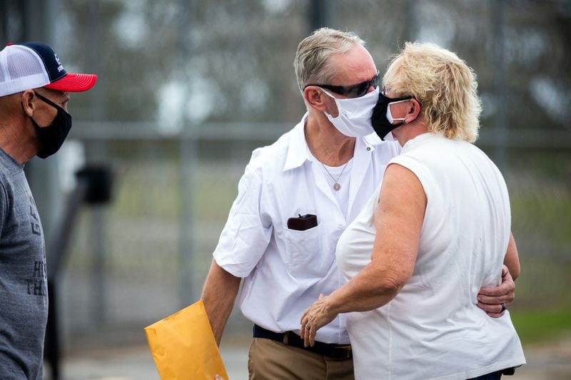 Dennis Perry is greeted by his wife Brenda Perry in front of the Coffee Correctional Facility, Thursday, July 23, 2020, in Nicholls, Ga. Perry was released after being behind bars for 20 years. (Stephen B. Morton for The Atlanta Journal-Constitution)