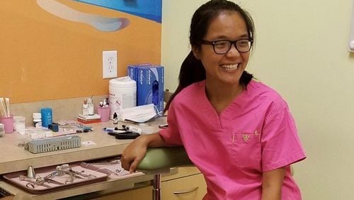 Niang Muang, pictured here shadowing a local dentist, has been accepted into dental school. (Courtesy of F.R.E.E.)