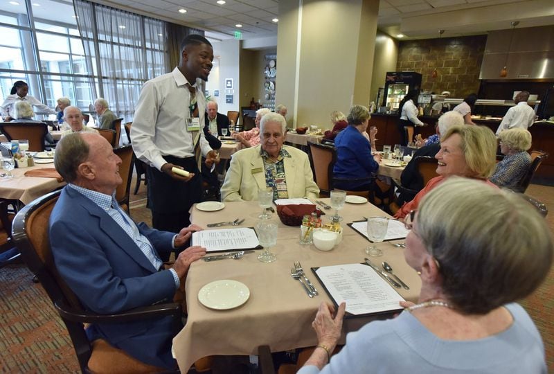 Vacom Sambola takes food orders from Lenbrook residents (clockwise from left) Reid Hunter, Harold Ramos, Barbara Ramos and Martha Hunter at The Grill in Lenbrook Senior Community in Buckhead. With multiple distinctly different dining venues, Lenbrook is at the leading edge of a wave of change coming to senior living communities. HYOSUB SHIN / HSHIN@AJC.COM