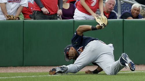 Atlanta Braves outfielder Micah Johnson rolls after diving to catch a fly ball in the sixth inning against the Philadelphia Phillies, Tuesday, March 14, 2017, in Clearwater, Fla.