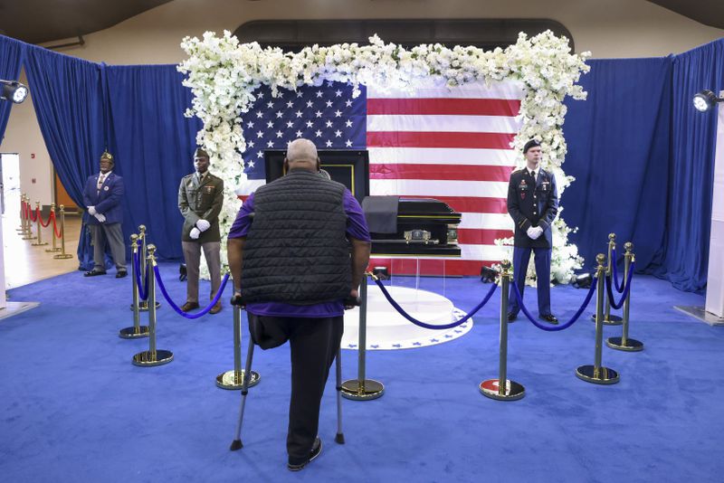 Rudy Solomon stands in front of the casket of Army Reservist Sgt. Kennedy L. Sanders at C.C. McCray City Auditorium, Friday, February 16, 2024, in Waycross, Ga. Sgt. Sanders was killed in a drone attack in late Jan. 28th in Jordan. (Jason Getz / jason.getz@ajc.com)