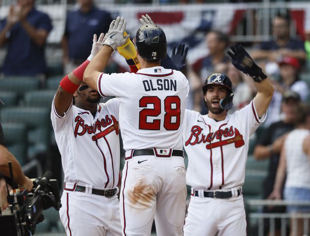 Atlanta Braves' Matt Olson celebrates his three-run homer during the ninth inning of game one of the baseball playoff series between the Braves and the Phillies at Truist Park in Atlanta on Tuesday, October 11, 2022. (Jason Getz / Jason.Getz@ajc.com)