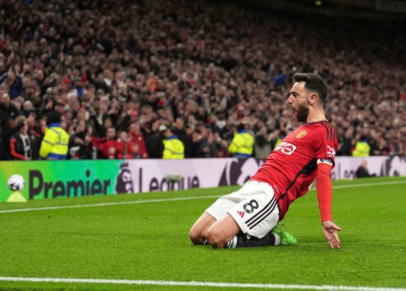 Manchester United's Bruno Fernandes celebrates scoring his side's third goal during the English Premier League soccer match between Manchester United and Sheffield at the Old Trafford Stadium in Manchester, England, Wednesday, April 24, 2024. (Martin Rickett/PA via AP)