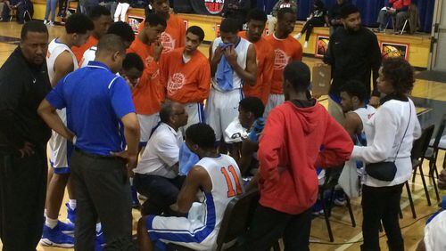 Columbia coach  Phil McCrary huddles with his team during a timeout