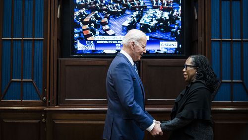 President Joe Biden and Judge Ketanji Brown Jackson watch as the Senate votes to confirm Jackson to the Supreme Court, from the Rosevelt Room of the White House in Washington on Thursday, April 7, 2022. (Al Drago/The New York Times)