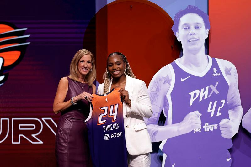 UCLA's Charisma Osborne, right, poses for a photo with WNBA commissioner Cathy Engelbert, left, after being selected 25th overall by the Phoenix Mercury during the third round of the WNBA basketball draft on Monday, April 15, 2024, in New York. (AP Photo/Adam Hunger)