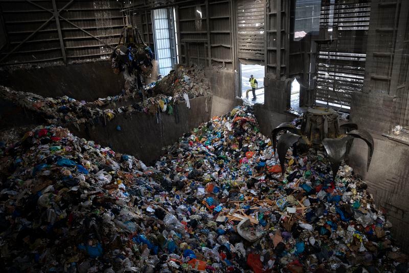 FILE - Cranes lift waste, mostly plastic and paper at the GreenNet recycling plant in Atarot industrial zone, north of Jerusalem, Jan. 25, 2023. (AP Photo/Oded Balilty, File)