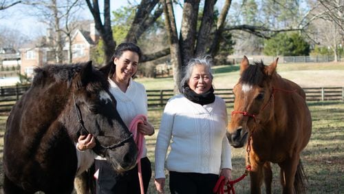 Joy Lim Narkin with draft horse rescue, Geronimo and her mother, Teresita Lim King, with senior rescue horse, Arabella at Joyous Acres. (Courtesy Joy Narkin)