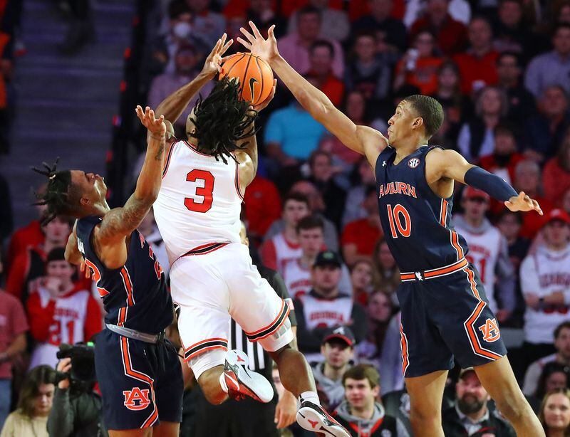 Georgia 's Kario Oquendo has his shot blocked by Auburn defender Jabari Smith (right) as he goes to the basket in a NCAA college basketball game on Saturday, Feb. 5, 2022, in Athens.  “Curtis Compton / Curtis.Compton@ajc.com”`