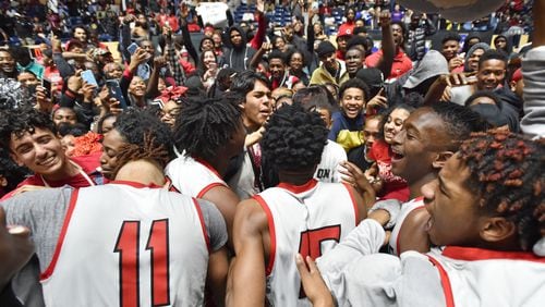 March 9, 2019 Macon - Tri-Cities players celebrate their victory in GHSA State Basketball Championship game at the Macon Centreplex in Macon on Saturday, March 9, 2019. Tri-Cities won 46-43 over the Tucker. HYOSUB SHIN / HSHIN@AJC.COM