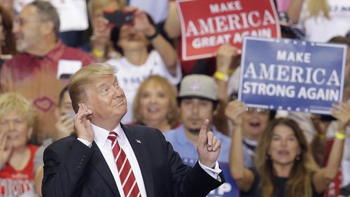 President Donald Trump gestures to the crowd while speaking at a rally at the Phoenix Convention Center, Tuesday, Aug. 22, 2017, in Phoenix. (AP Photo/Rick Scuteri)