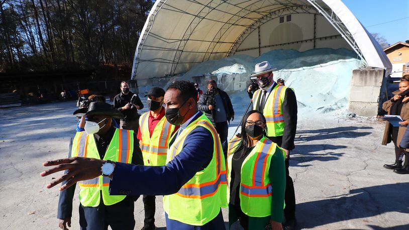 012722 Atlanta:  Atlanta Mayor Andre Dickens (center from left),  Congresswoman Nikema Williams and Atlanta Department of Transportation Commissioner Josh Rowan take in a salt barn during a tour of the ATLDOT North Avenue facility following a press briefing on how the Infrastructure Investment and Jobs Act will invest in Atlanta’s infrastructure on Thursday, Jan. 27, 2022, in Atlanta.   “Curtis Compton / Curtis.Compton@ajc.com”`
