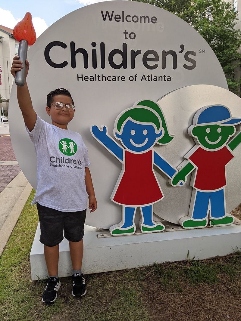 Andrew Jimenez in March 2021, ringing a bell to celebrate his completion of chemotherapy treatment.