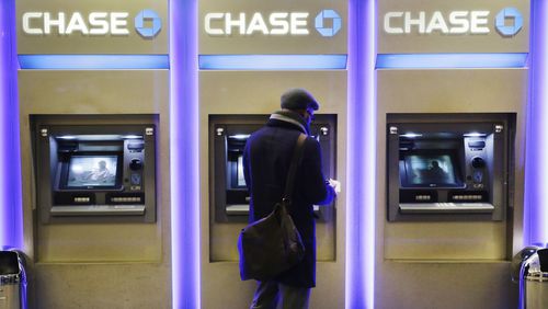 A customer uses an ATM at a branch of Chase Bank in New York. The ATM recently turned 50. (AP Photo/Mark Lennihan, File)