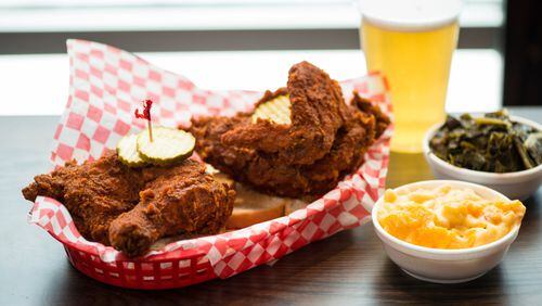 Hattie B's Hot Chicken 1/2 Bird Plate served with two sides, bread, and pickles. Pictured are Pimento Mac and Cheese and Southern Greens sides with a draft beer. Photo credit- Mia Yakel.