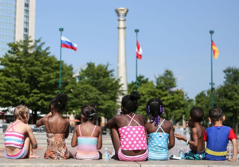 A group of children in the Bright Horizons summer camp program sit beside the Fountain of Rings in Centennial Olympic Park in 2016. Centennial Olympic Park was home to the games in 1996, and is now open to the public for music concerts and a famous firework show on the Fourth of July. The park is surrounded by several Atlanta landmarks such as the CNN Center and the College Football Hall of Fame.    EMILY JENKINS/ EJENKINS@AJC.COM