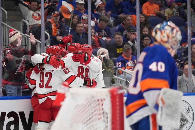 The Carolina Hurricanes celebrate a goal by Stefan Noesen as New York Islanders goaltender Semyon Varlamov (40) loolks away during the third period of Game 4 of an NHL hockey Stanley Cup first-round playoff series Saturday, April 27, 2024, in Elmont, N.Y. (AP Photo/Frank Franklin II)