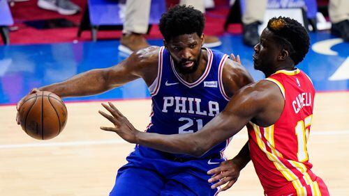 Philadelphia 76ers' Joel Embiid, left, tries to get past Atlanta Hawks' Clint Capela during the first half of Game 2 in a second-round NBA basketball playoff series, Tuesday, June 8, 2021, in Philadelphia. (AP Photo/Matt Slocum)