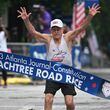Bill Thorn ends his 53-year streak at the finish line of The Atlanta Journal-Constitution Peachtree Road Race in Atlanta on Tuesday, July 4, 2023. Thorn, 92, is the only person to run every Peachtree Road Race since it began in 1970. This year he served as grand marshal. (Hyosub Shin / Hyosub.Shin@ajc.com)
